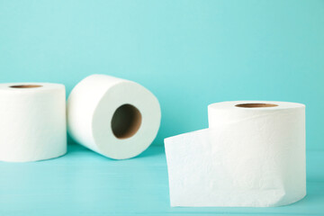 Toilet paper on blue background with copy space