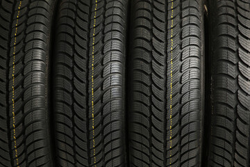 Four tires stack background. Selective focus. top view