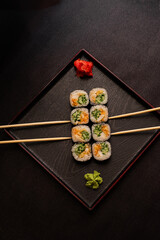 sushi hot rolls on black background dish japanese cuisine