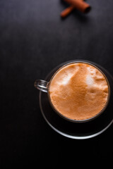 A cup of hot coffee latte cappuccino with cinnamon
