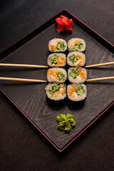 sushi hot rolls on black background dish japanese cuisine