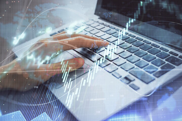 Double exposure of woman hands typing on computer and forex chart hologram drawing. Stock market analysis concept.