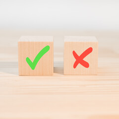 Voting, poll, checklist decision making or evaluation. Tick mark and cross mark x on wooden cubes....