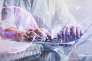 Double exposure of woman hands typing on computer and forex chart hologram drawing. Stock market...