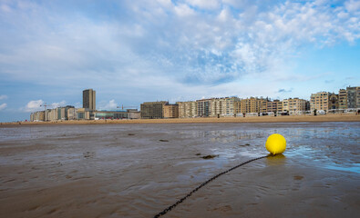 Bright yellow buoy on the beach of Ostend, Belgium.