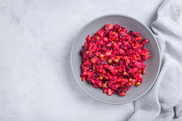 Traditional beetroot russian salad is vinaigrette in bowl