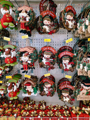 Christmas decorations on a showcase in a supermarket - Christmas wreath with a snowman and Santa Claus.