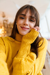 Charming happy nice girl taking selfie photo and smiling indoors
