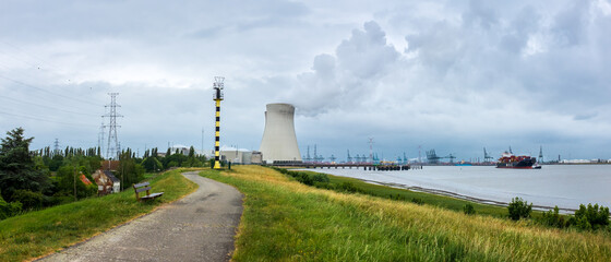 Panoramic view of the nuclear power plant of Doel, with a large container vessel on the nearby river Scheldt.