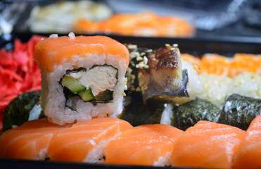 Rolls with salmon and tuna, cream cheese, avocado, eel. Sushi. Figure: