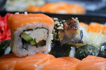 Rolls with salmon and tuna, cream cheese, avocado, eel. Sushi. Figure:
