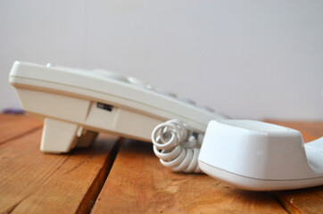 Old landline telephone set for calls in white.