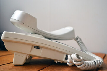 Old landline telephone set for calls in white.