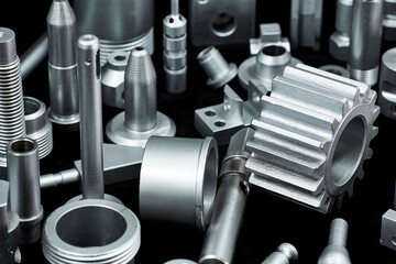 Shiny steel parts on a black background. Regular industrial metal production pattern.