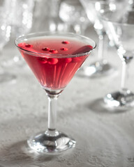 A glass of cocktail with red currants
