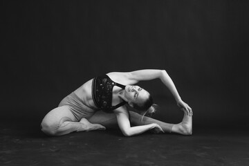 Fototapeta na wymiar Black and white photo of yoga girl performing asana.