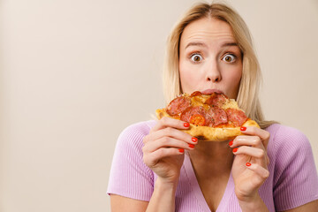 Shocked beautiful blonde girl eating pizza on camera