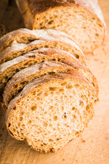 Sliced homemade bread on the wooden cutting board. Selective focus. Shallow depth of field.
