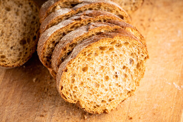 Sliced homemade bread on the wooden cutting board. Selective focus. Shallow depth of field.