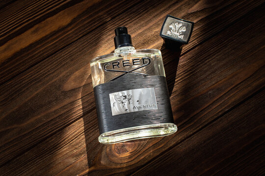 Creed Aventus 120 ml eau de parfum bottle on a wooden table surface