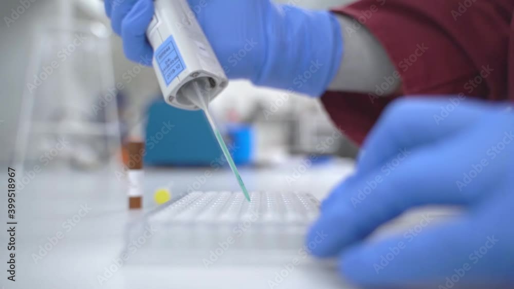 Wall mural Hands of a scientist who works with pipette and a test tube. Research technician in the genetic laboratory. medical and research banner