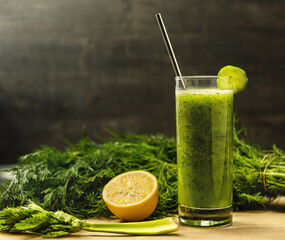 Glass of fresh cucumber juice with dill and lemon with stainless steel drinking straw. Healthy vegetable-based drink with natural, farm-fresh ingredients