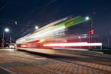 Fototapeta na wymiar Tram in motion. Station of public transportation at night. Prague, Czech Republic