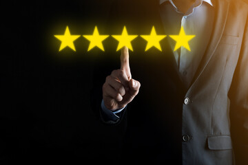 Man hand showing on five star excellent rating.pointing five star symbol to increase rating of company.Review, increase rating or ranking, evaluation and classification concept