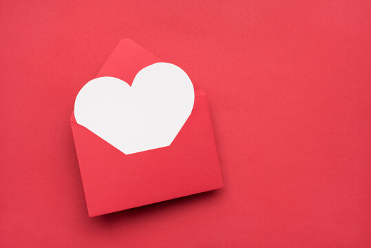 Happy Valentines day concept. Top above overhead close up view photo image of open envelope and white greeting card inside with copy space isolated bright color texture table