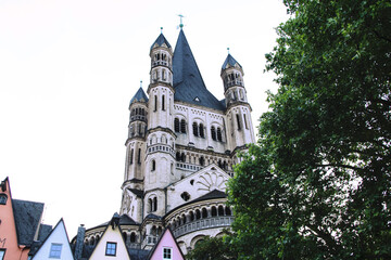 Fototapeta premium The Gothic Cathedral of Cologne in the beautiful city at sunset the details of the towers and decorations are sublime, near the river and the bridge in the background. Germany.