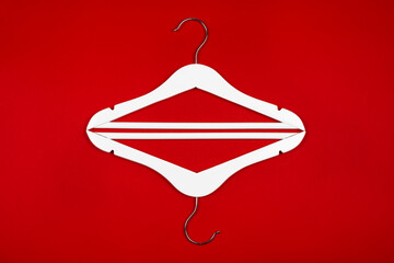 White hangers on a red background. Sales clothes concept.