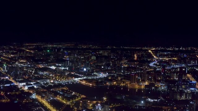 Russia, Ekaterinburg, lights of the night city. Stock footage. Aerial view of a big city with shining streets, lanterns , and road on black sky background.