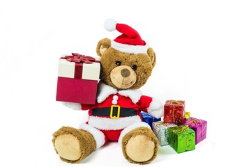 A teddy bear doll wearing santa set, carry gift box  isolated on white background,Christmas day and New Year's gifts