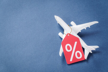 Airplane model with percent symbol tag with copy space. Air travel discounts