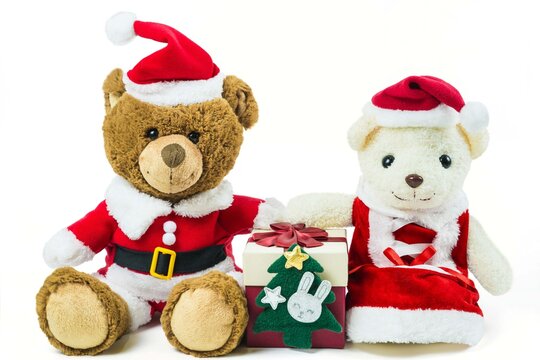 Couple teddy bear doll wearing santa set with many colorful red gift box isolated on white background,Christmas day and New Year's gifts