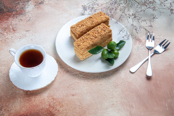 top view yummy cake slices honey cake with tea on light background pie biscuit sweet cake