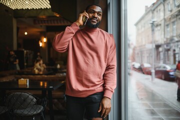 Fototapeta premium mature african american man talking by phone in cafe