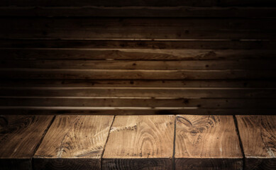 Old wooden tabletop and wooden wall at the background.