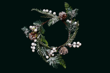 Christmas wreath on dark green background top view, tree fir branches with cones, New Year's decorations. Isolated, tidewater trend 2021 color