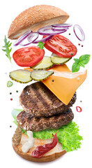 Tasty delicious hamburger ingredients flying in the air layer upon layer. Clipping path.