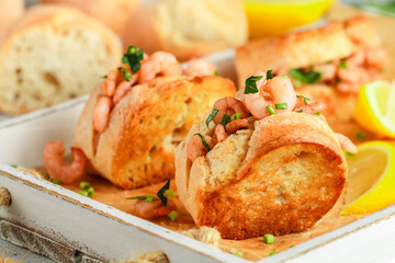 Delicious shrimp and parsley sandwiches, served with lemon and spices. Warm seafood rolls. Selective focus