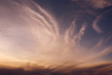 Evening vibrant cloudy sky with purple, orange and blue colors