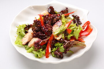 Salad with grilled octopus and potatoes on a white plate. Tasty starter for a dinner.