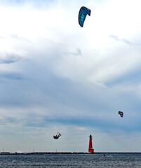 Kite-boarders windsurfing on a partly cloudy day