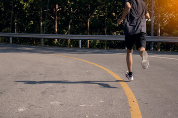 Men jogging in the morning on the park road