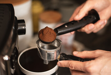 Man making espresso at his coffee station at home. Selective focus