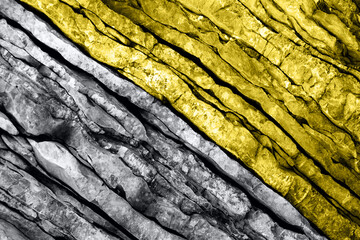 Textured layers and cracks in the rock on cliff face.