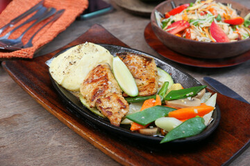 grill fish fillet with fresh salad on plate close up 