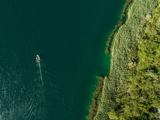 Aerial view of boat on Bacina fresh water lakes in South Dalmatia, Croatia.