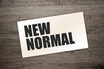 words New normal card on wooden table. healthcare or business lifestyle concept.